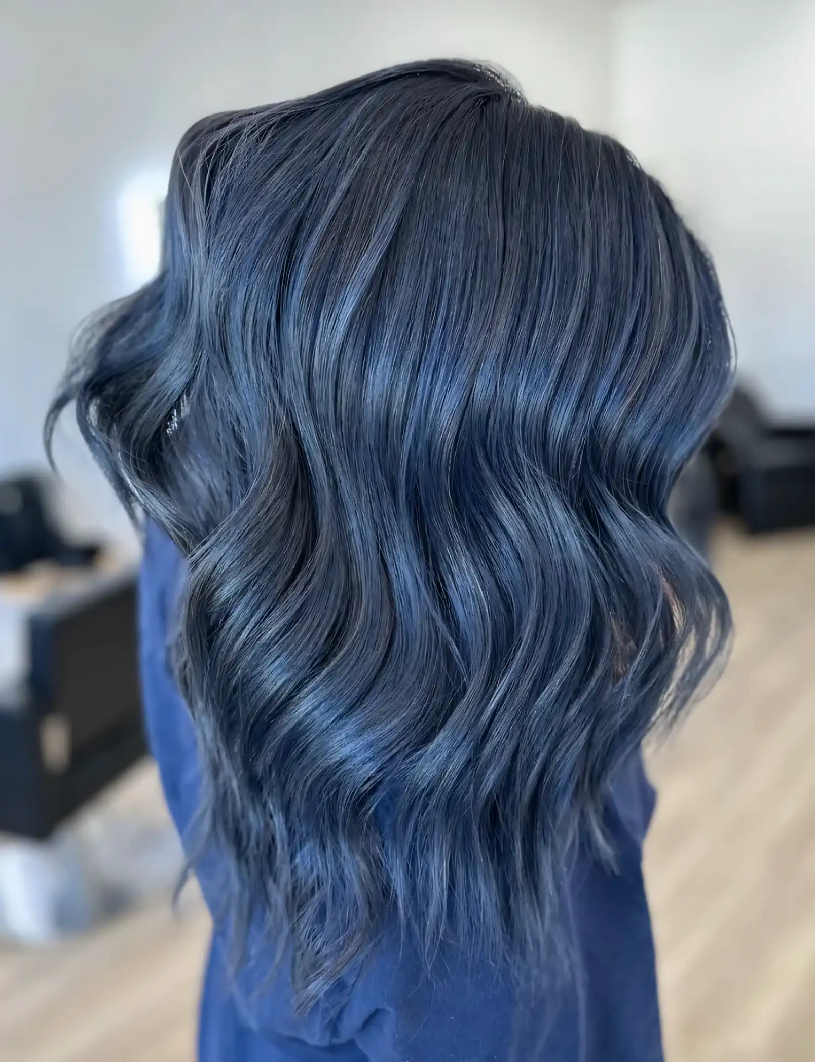 Dark ashy wavy hair with smoky denim blue tones