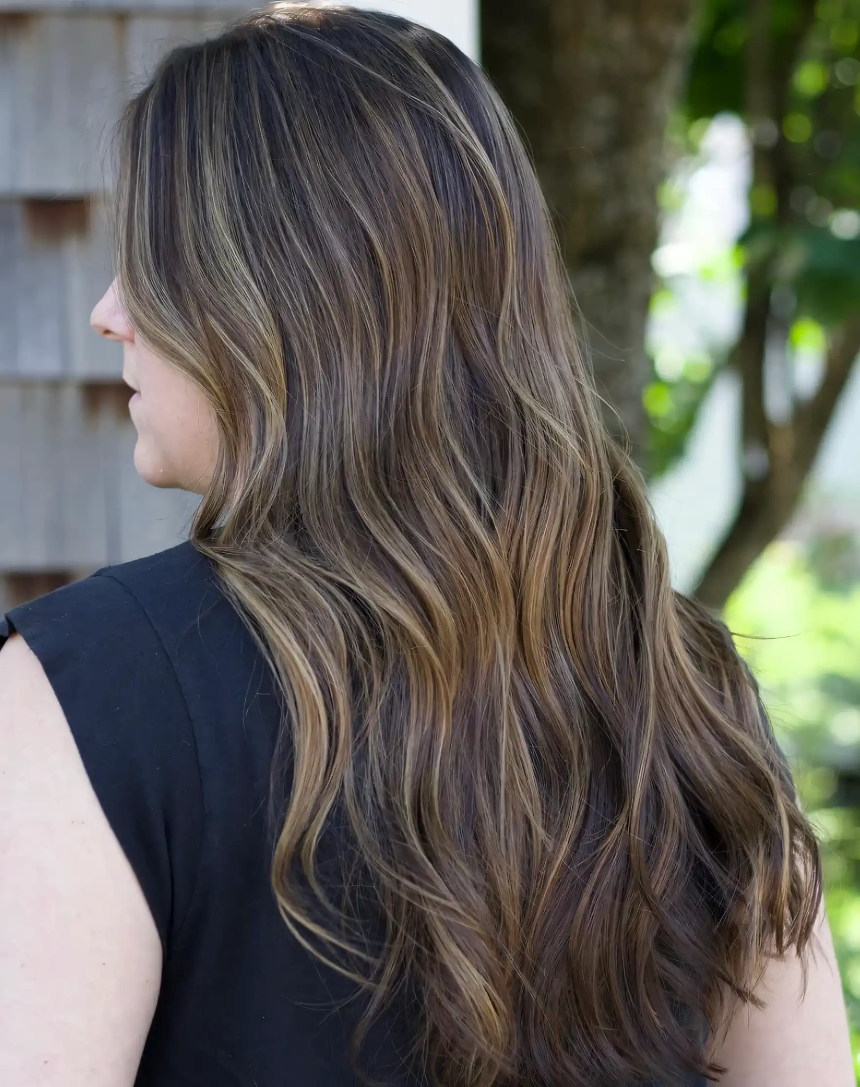 Long brown wavy hair with muted olive toned highlights
