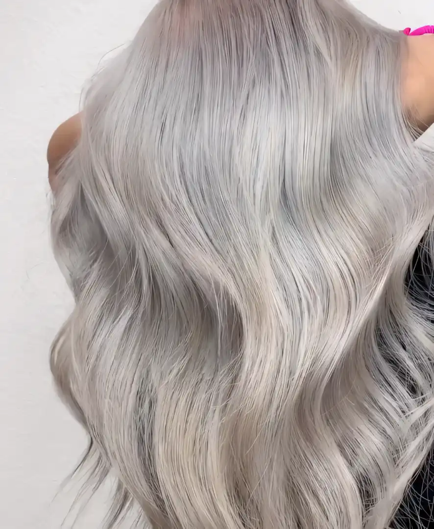 Long silver gray wavy hair with brighter platinum highlights