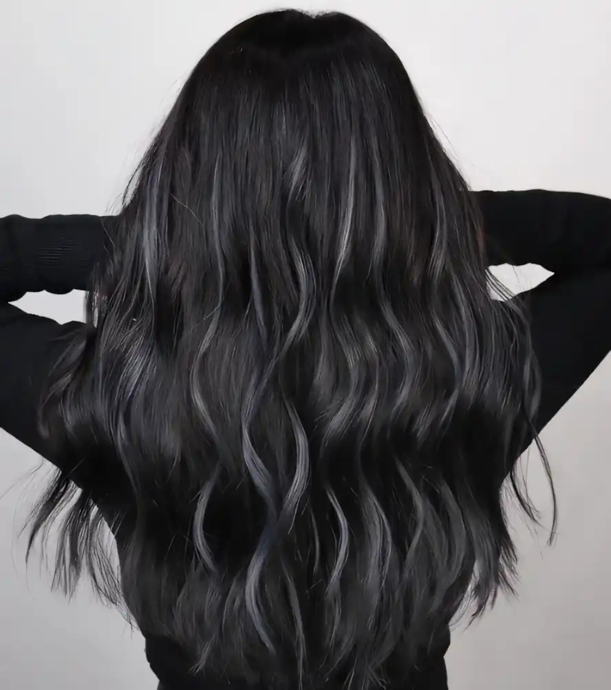 Long wavy black hair with subtle smoky gray highlights