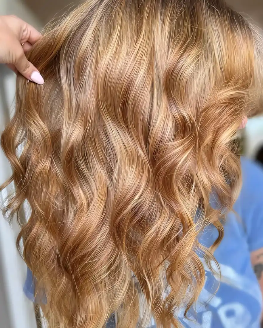 Golden blonde curled hair with soft strawberry blonde warmth