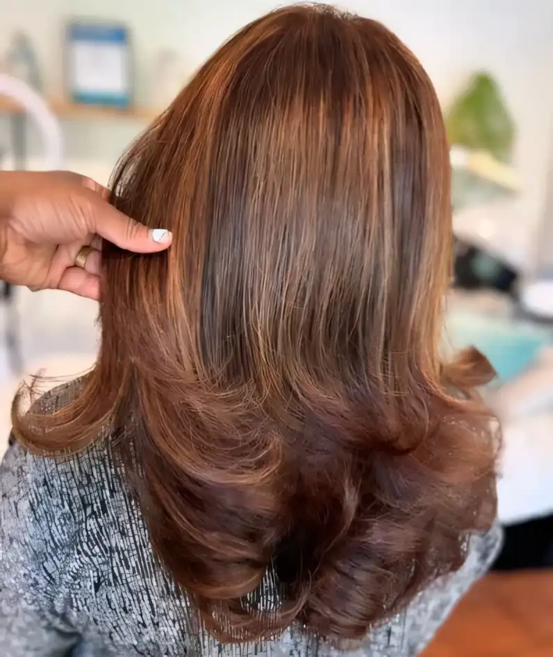 Layered medium brown hair with toffee caramel highlights