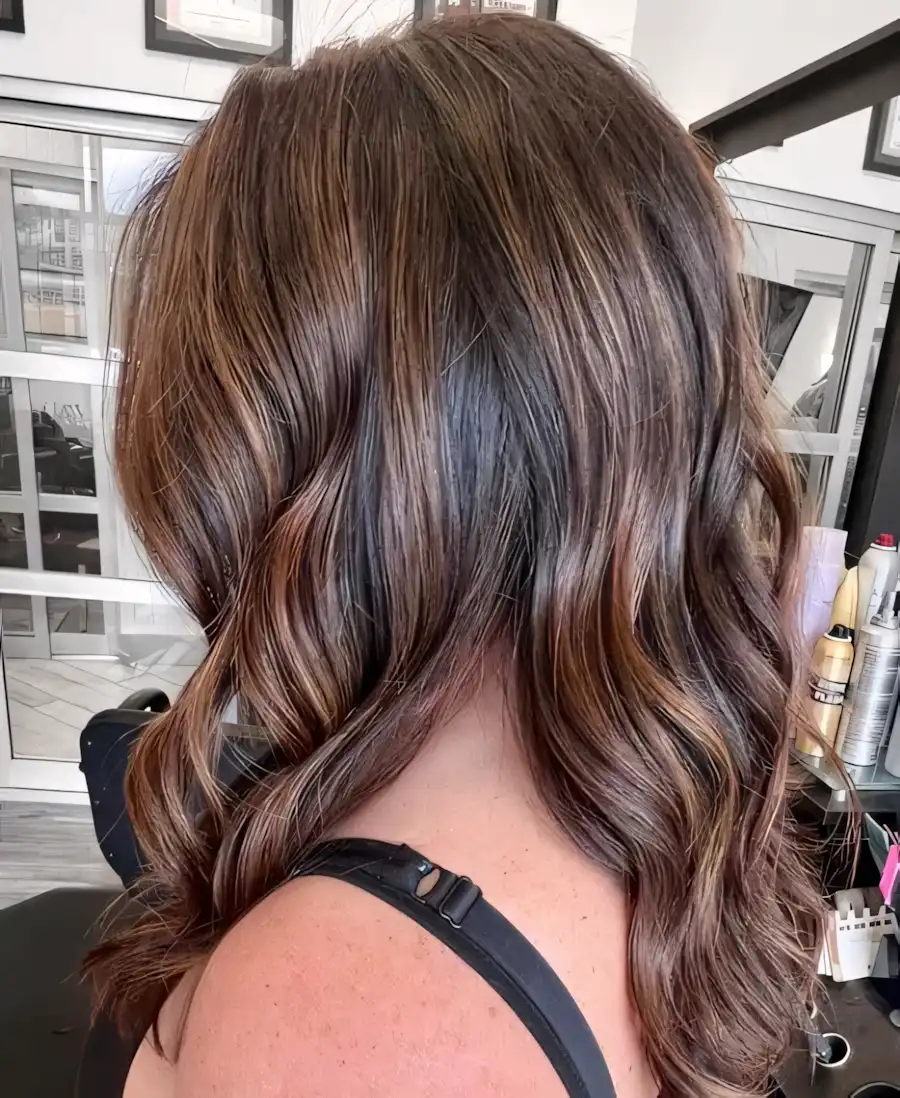Shoulder length brunette waves with natural auburn highlights