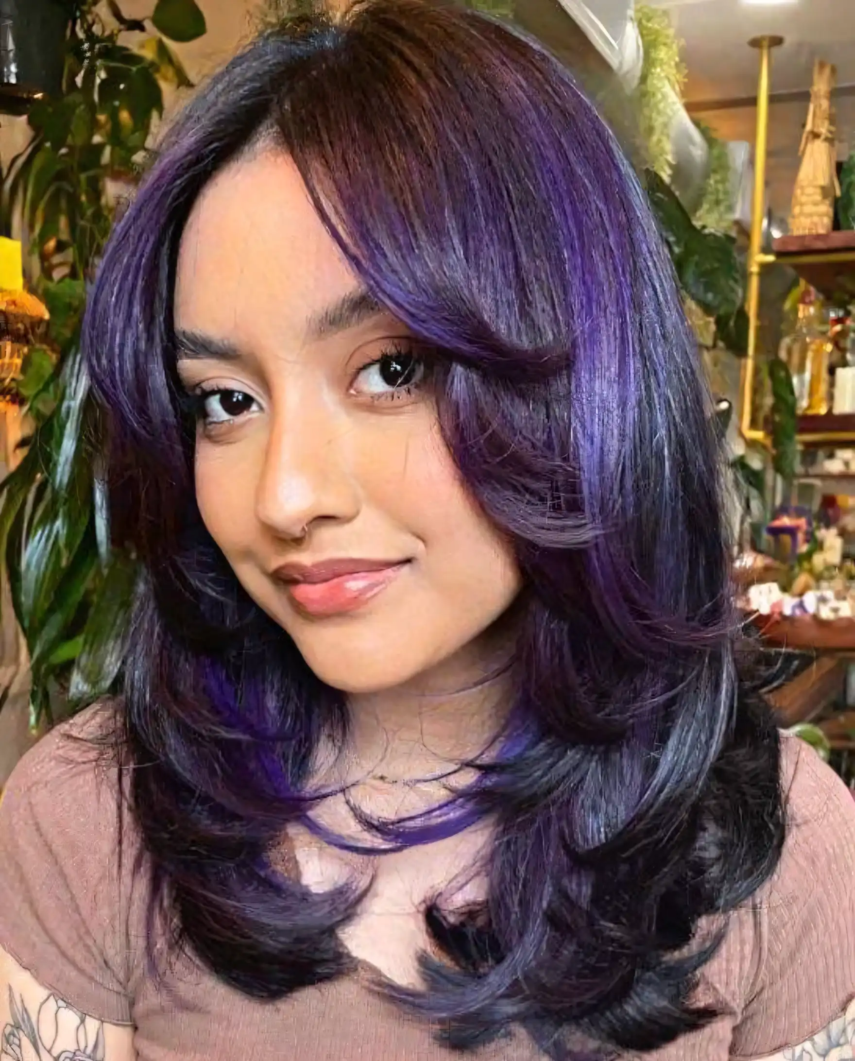 Dark medium layered hair with electric violet purple highlights